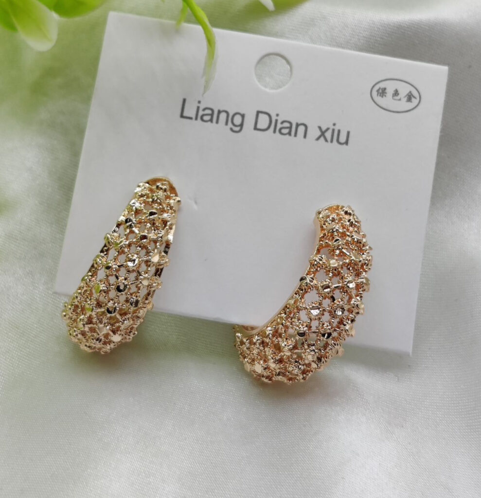 Imported Elegant Textured Hoop Earrings ? Dazzling Gold Finish Earrings - Luxurious Gold Finish | Best Quality Artificial Earrings For Girls & Women Description: Enhance your jewelry collection with these stunning textured hoop earrings. Crafted with intricate latticework and a luxurious gold-tone finish, these earrings exude sophistication and charm. Perfect for both casual outings and formal events, their versatile design ensures you?ll always stand out in the crowd. Lightweight and comfortable to wear, these hoops are your go-to accessory for an effortlessly chic look. Key Features: ? Exquisite lattice texture for added elegance ? High-quality gold-tone finish for a luxurious touch ? Lightweight and comfortable for all-day wear ? Ideal for any occasion: casual, formal, or festive ? Easy-to-wear secure clasp Original Video